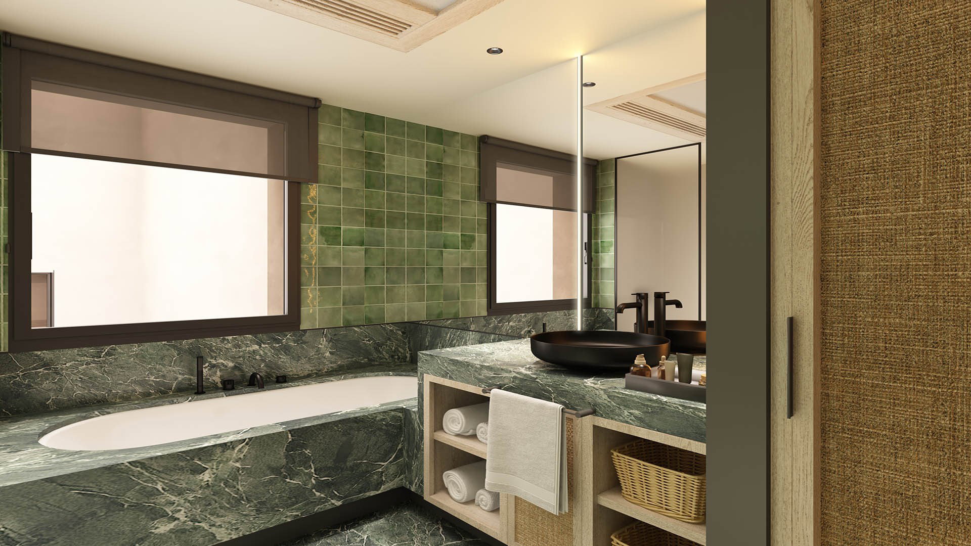Baño con bañera encastrada en mármol verde bajo la ventana, lavabo negro sobre la encimera y pared de azulejo verde