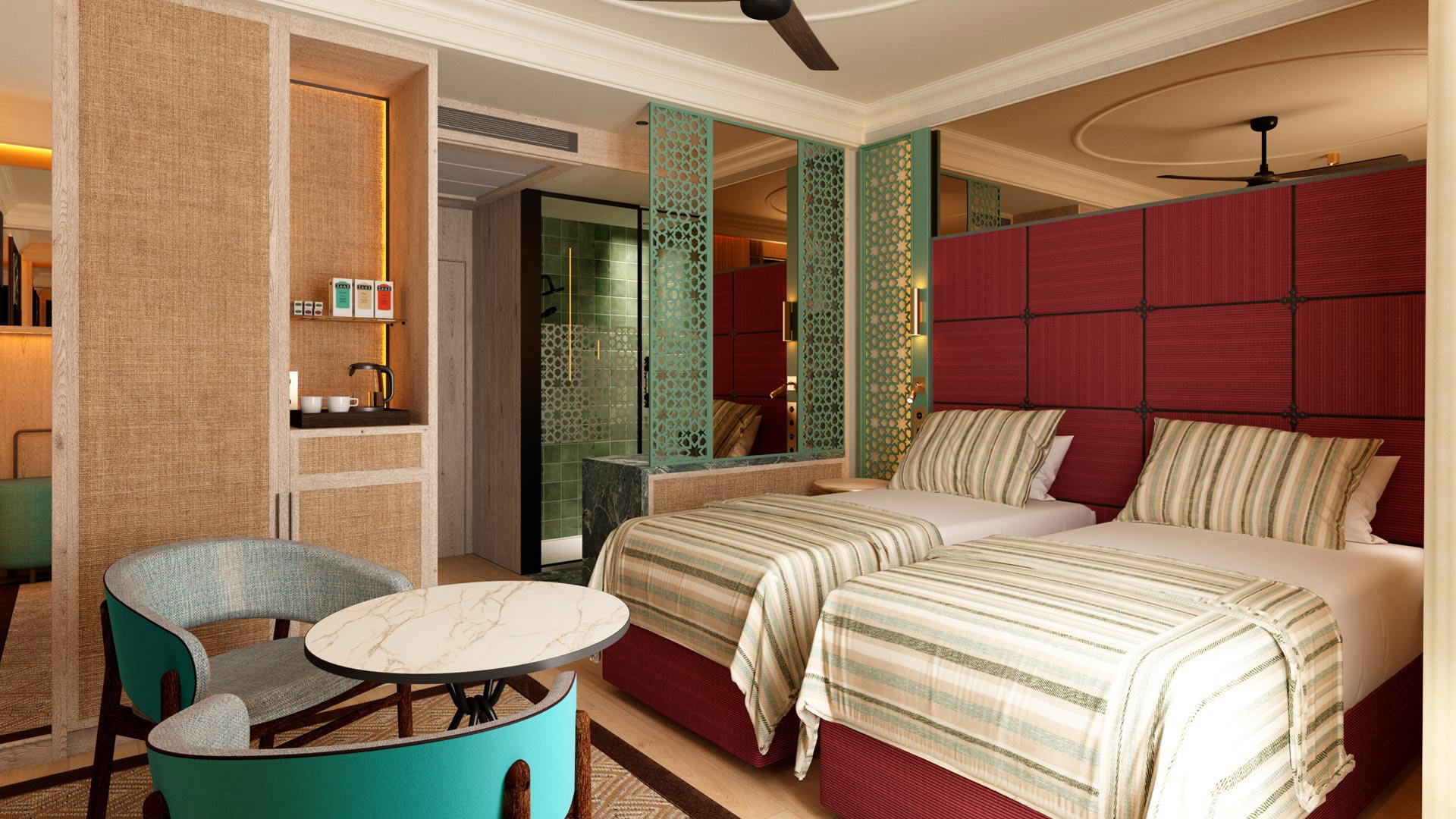 Habitación con dos camas individuales de cabecero granate, butacas turquesa y rincón de café