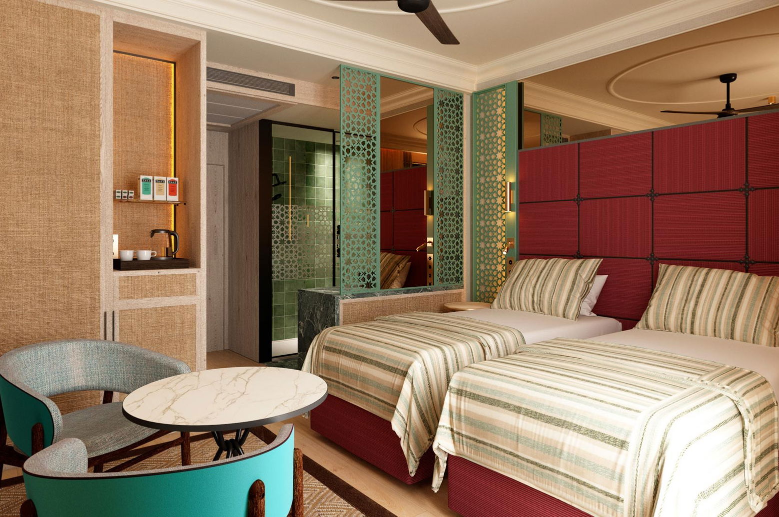 Habitación con dos camas individuales de cabecero granate, butacas turquesa y rincón de café