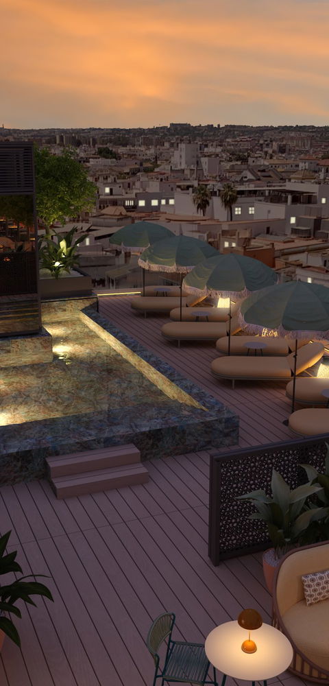 Piscina de la azotea iluminada al atardecer con tumbonas y vistas panorámicas de Sevilla