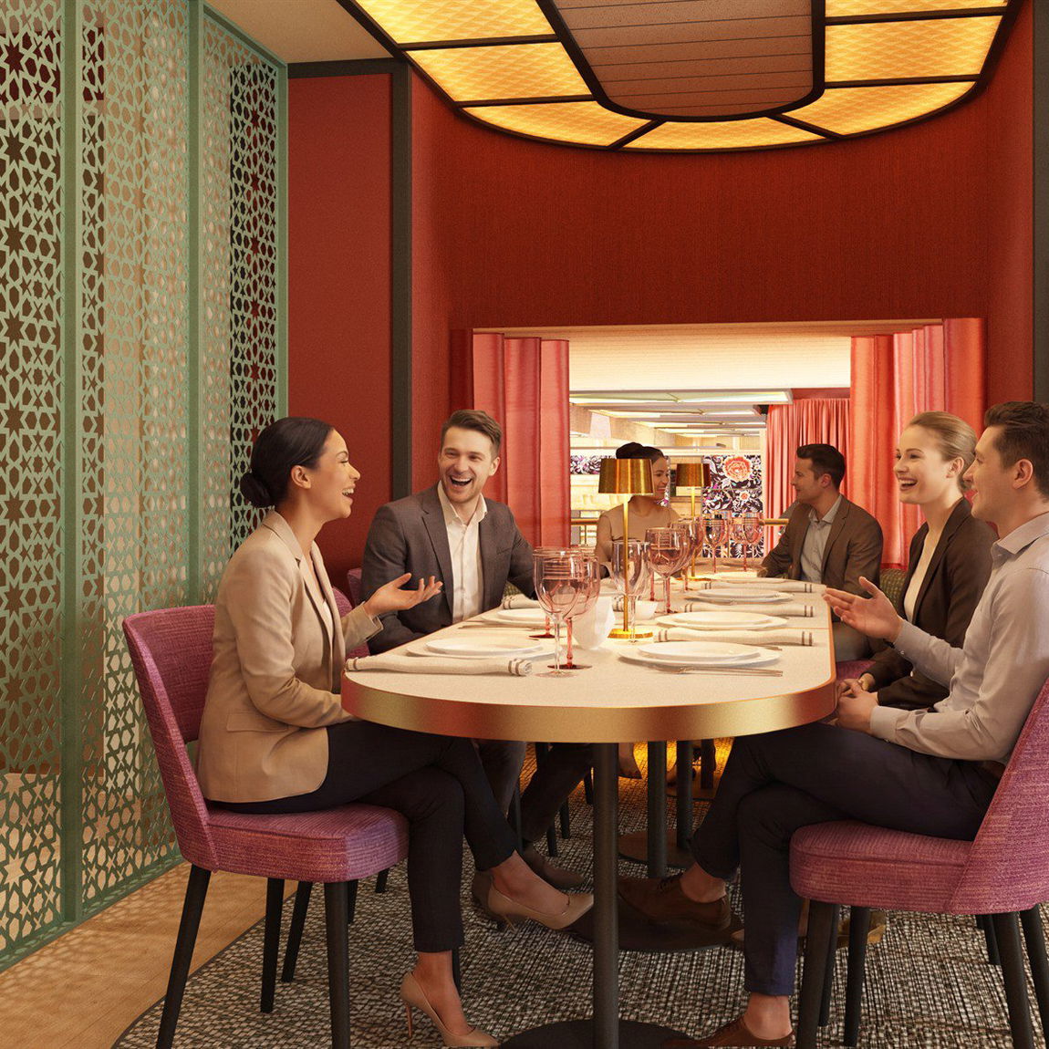 Sala privada con mesa redonda preparada para un grupo, sillas en tonos rosa y granate