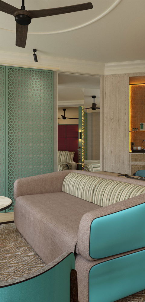 Salón de suite con sofá verde azulado, mueble de almacenaje verde y mesa redonda