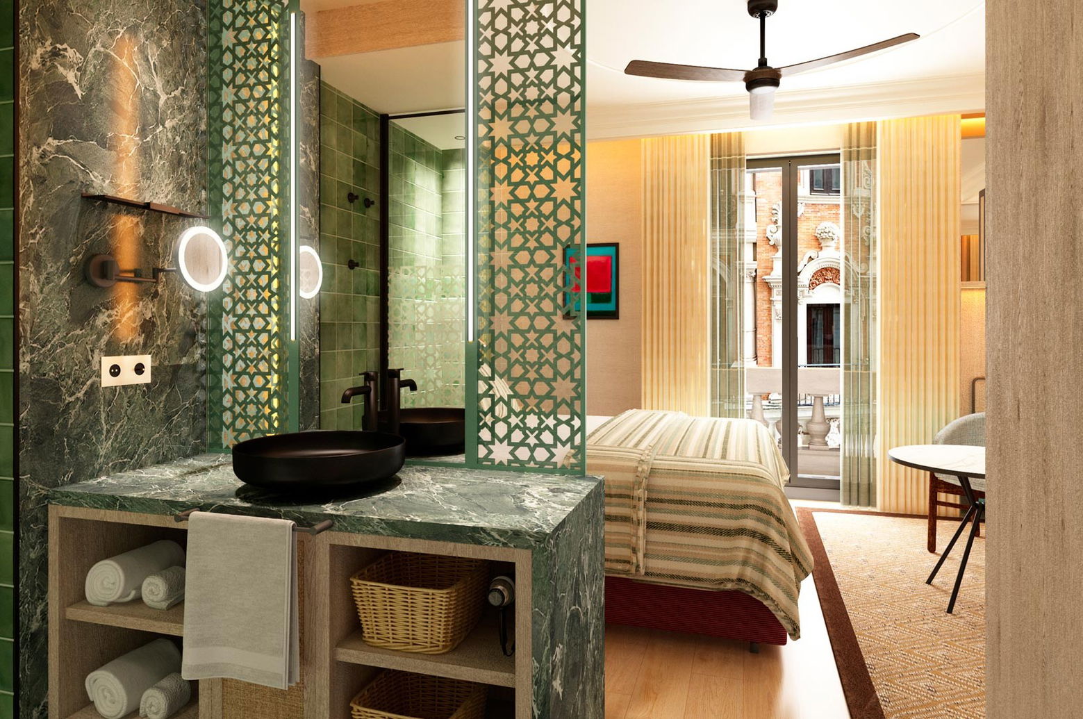Lavabo negro sobre mármol verde y, al fondo, la cama y el balcón con fachada de ladrillo